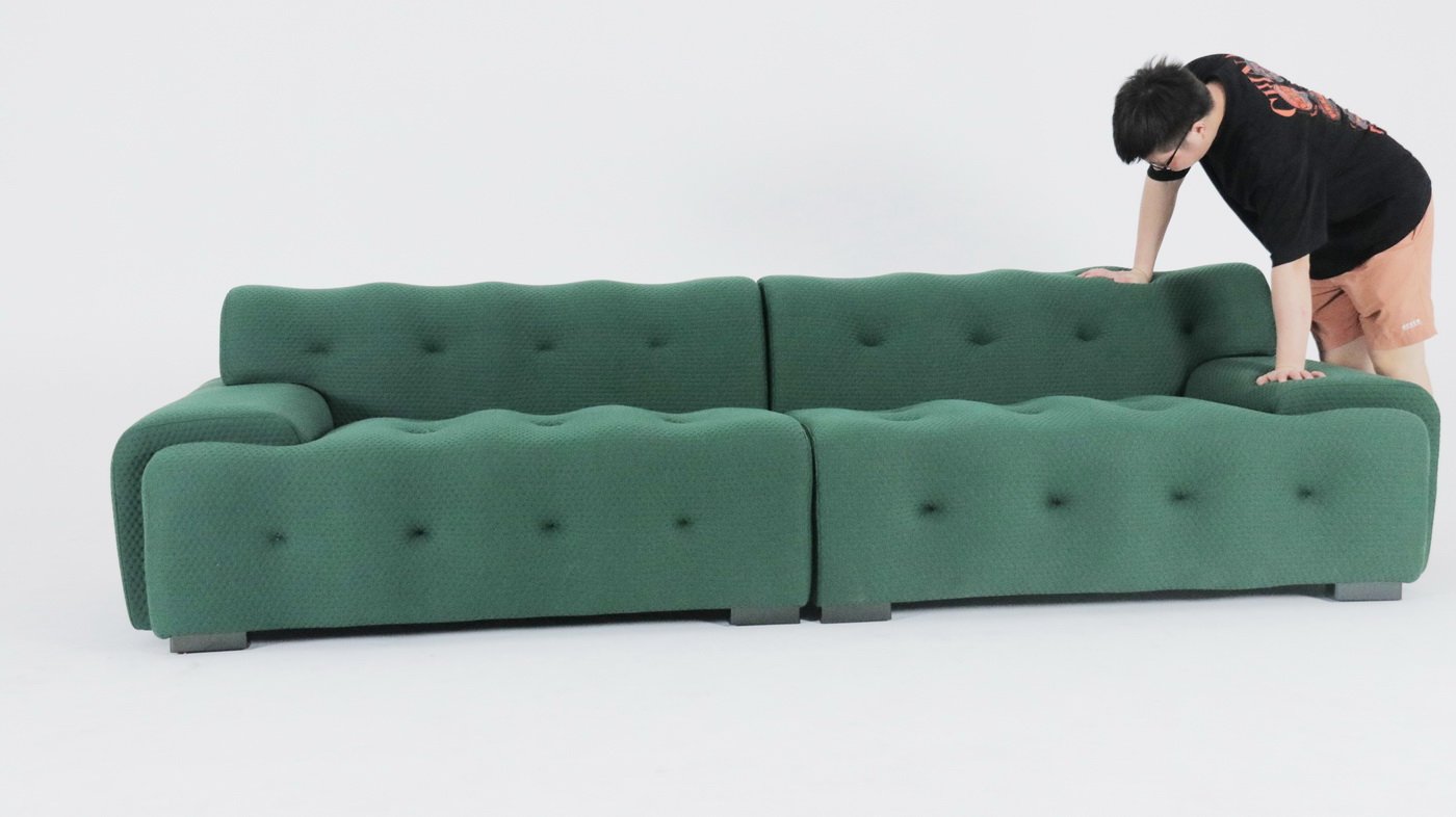 Blogger Sofa with tufted green or grey upholstery and modern design.