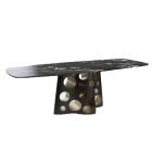 Cheese Dining Table with black and gold stainless steel base and marble top in modern sculptural design.