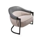 Modern lounge chair with curved leather backrest, quilted velvet seat, and sculptural metal base